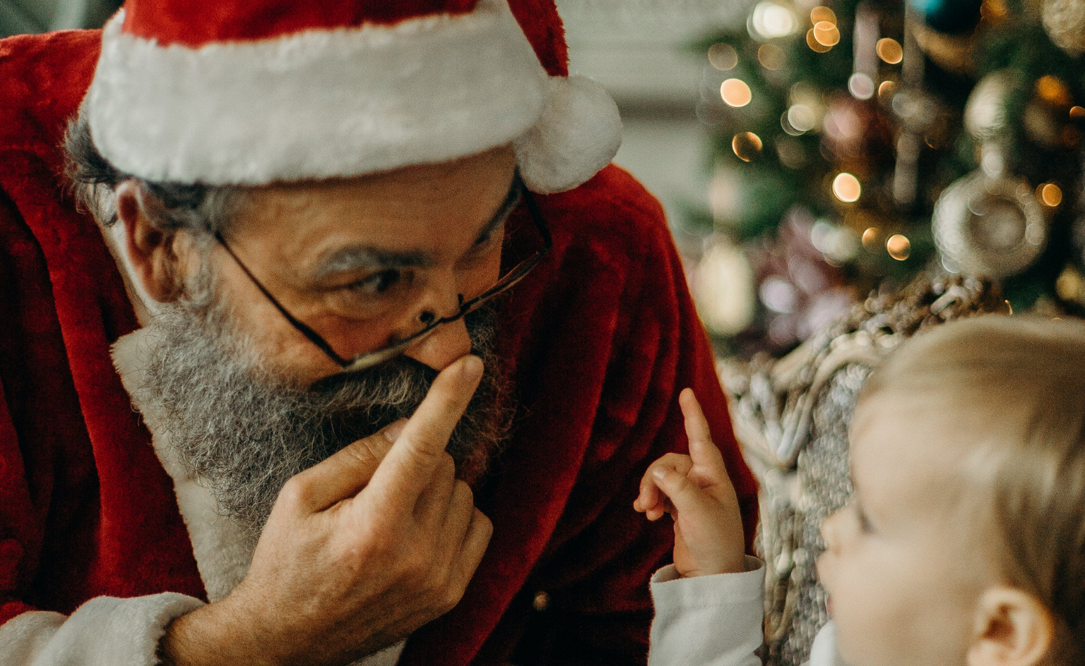 Santa Clause smiling with a child